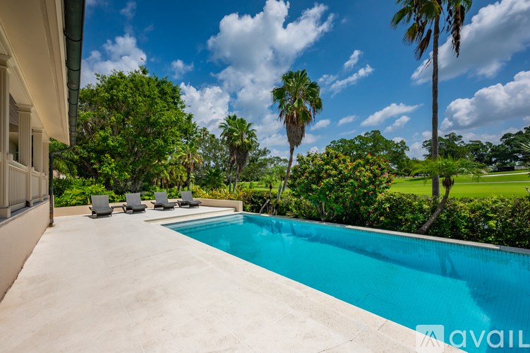 A pool surrounded by a lush green landscape.