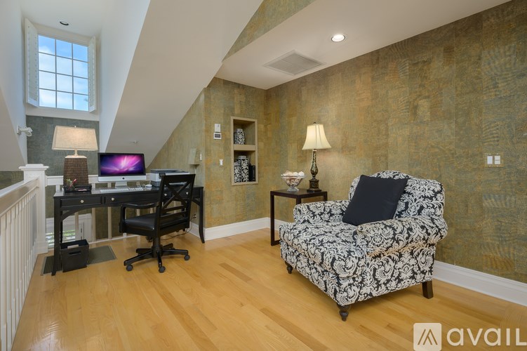 A room with a chair, a desk, and a computer.