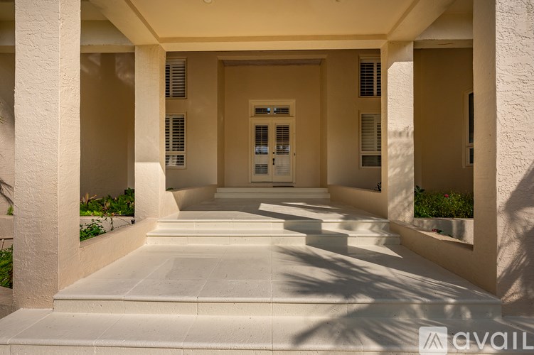 A building entrance with a set of stairs leading up to a door.