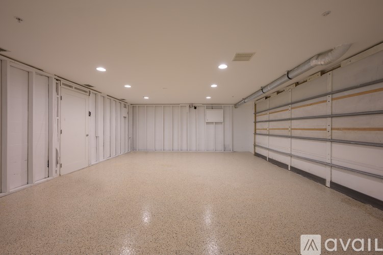 A spacious garage with white walls and a concrete floor.