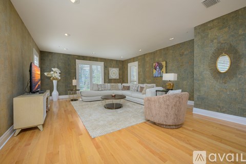 A living room with a white couch and a television.
