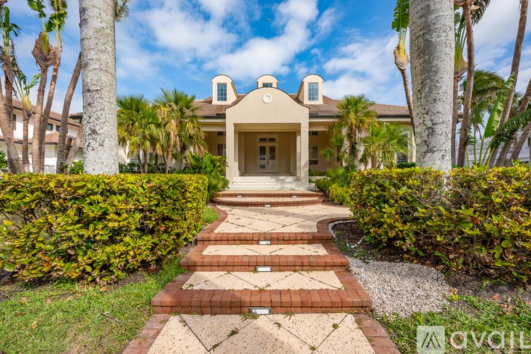 A house with a staircase leading to the front door.