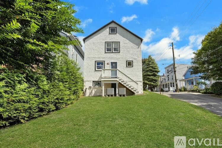 A house with a lawn in front of it is for sale.