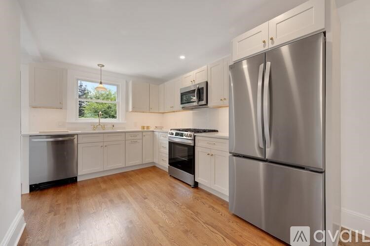 A kitchen with a stainless steel refrigerator, dishwasher, and oven.
