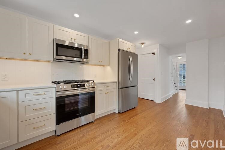 A kitchen with white cabinets and stainless steel appliances.
