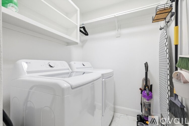 A white laundry room with a washer and dryer.