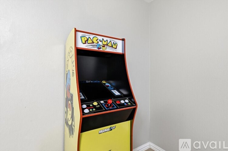A Pac-Man arcade machine is available for play.