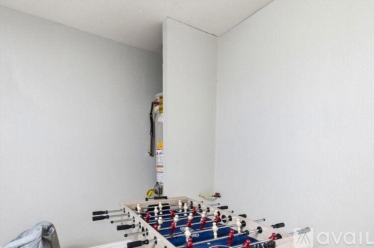 A foosball table in a room with white walls.