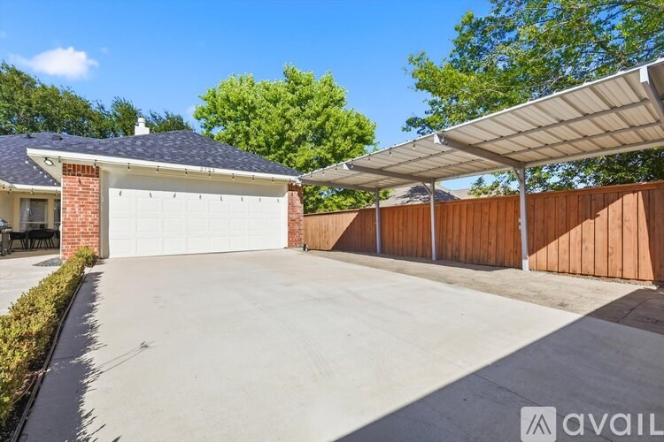 A house with a covered garage and a patio area.