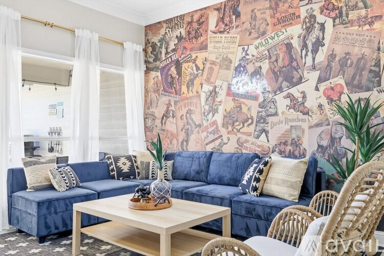 A living room with a blue couch and a wall covered in comic book covers.