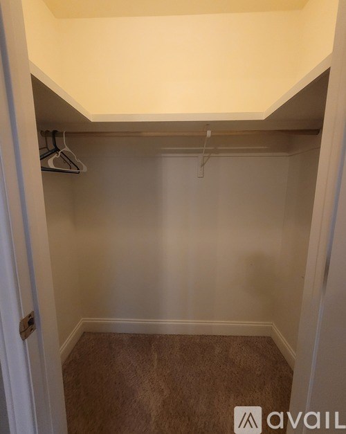 A small, empty room with a closet and a door.
