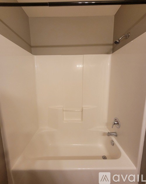 A white bathroom with a tub and a shower.