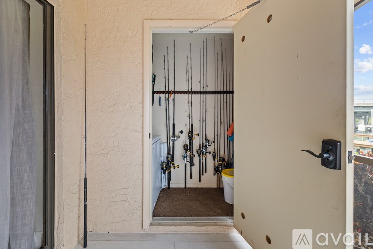 A room with a white door and a wall with a few holes in it.