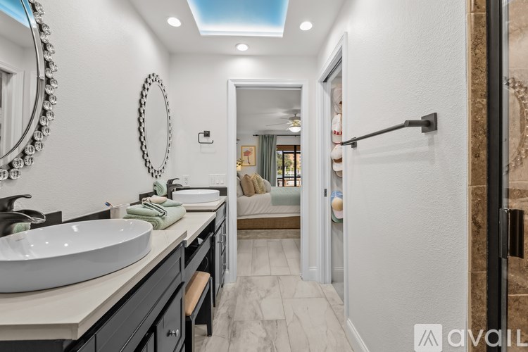 A bathroom with a white sink and a mirror.
