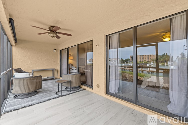 A balcony with a chair and a table.