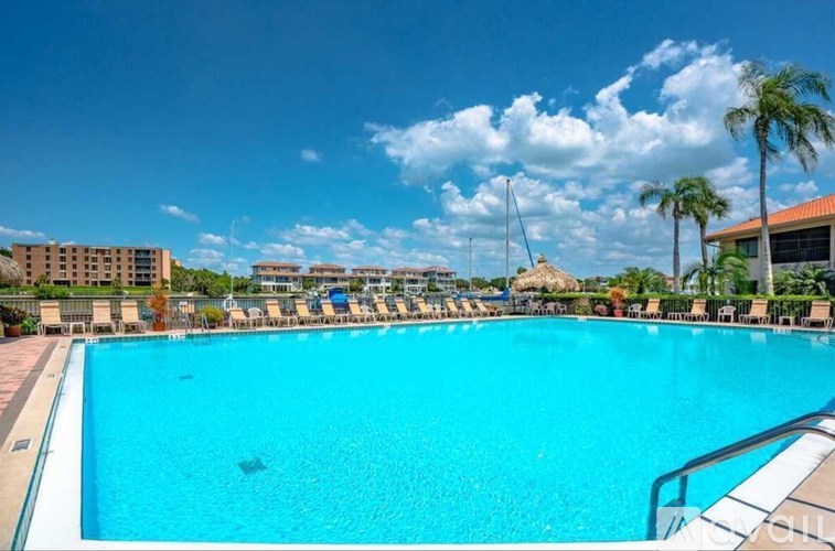 A large swimming pool with a metal railing on the side.