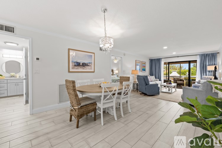 A dining room with a white table and chairs.
