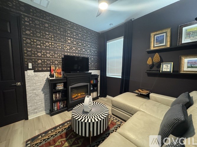 A living room with a fireplace and a television.