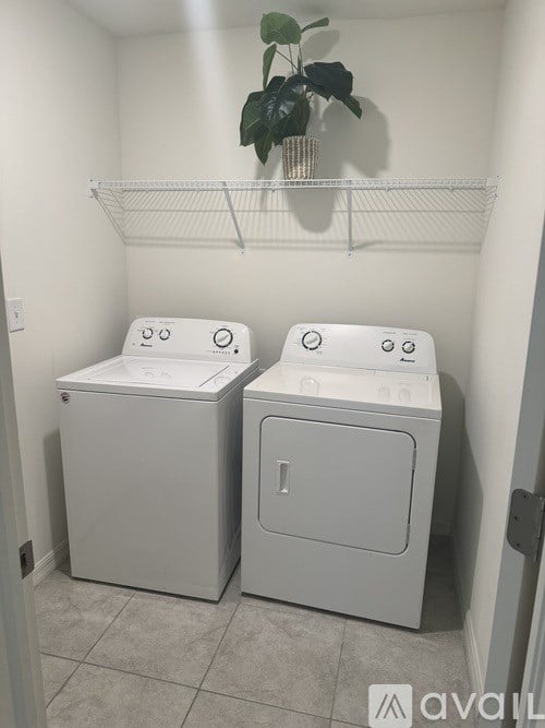 A small laundry room with a washer and dryer.
