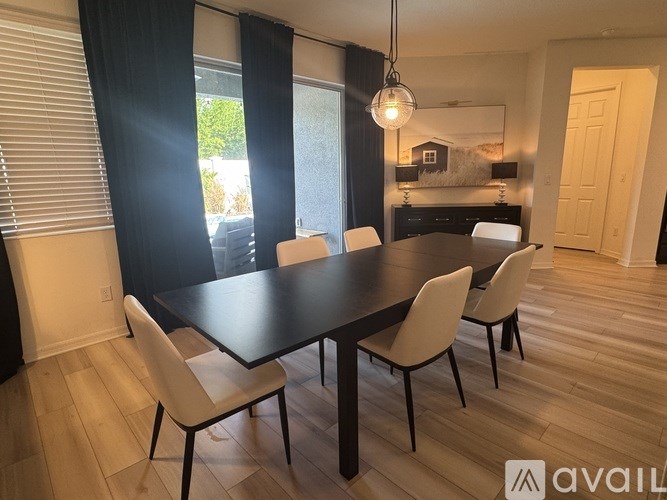 A dining room with a table and chairs.