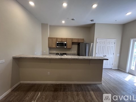 A kitchen with a countertop and cabinets is available for rent.