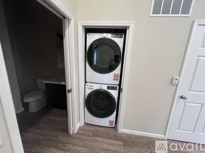 A washer and dryer are in a small laundry room.
