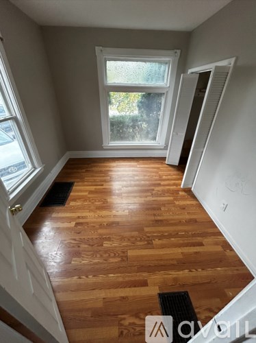 A room with wooden floors and a window.