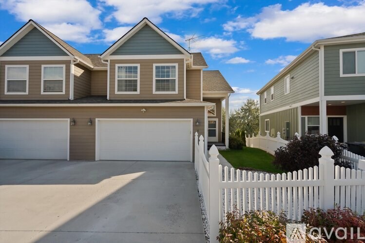 A house with a white picket fence in front.
