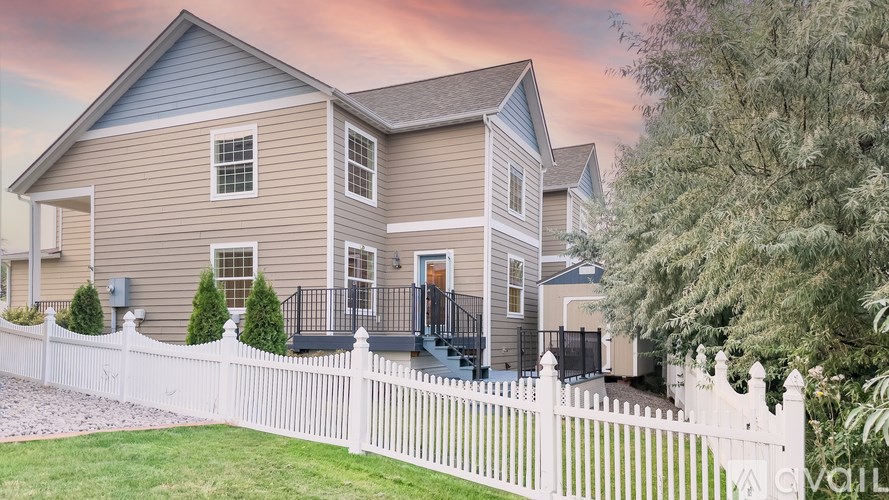 A house with a white picket fence in front of it.