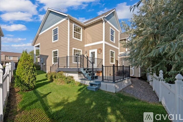 A house with a white picket fence in front.