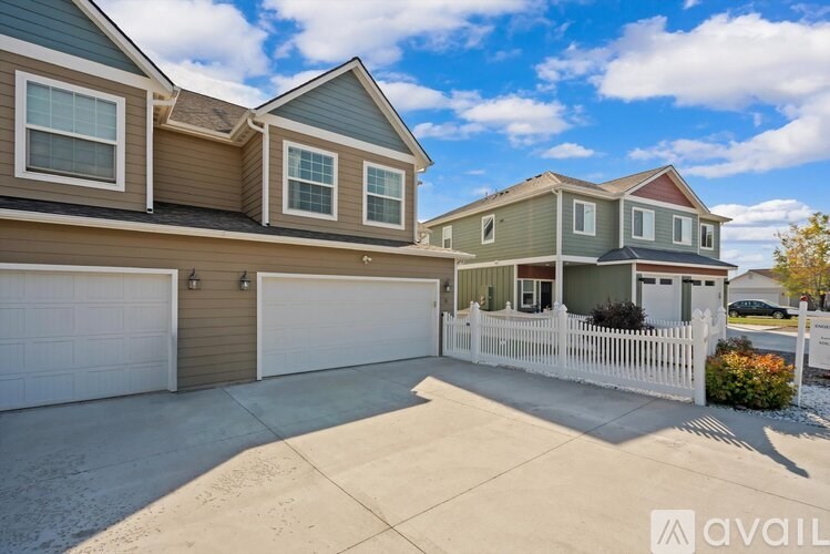 A house with a white picket fence is for sale.