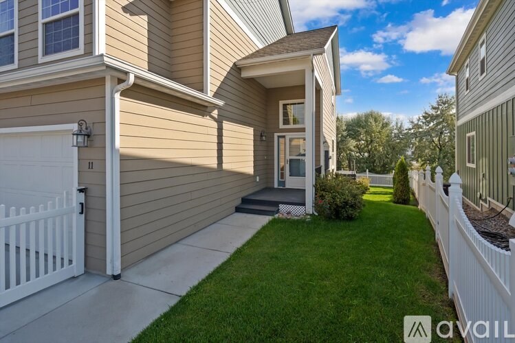 A house with a white fence and a small garden in front.