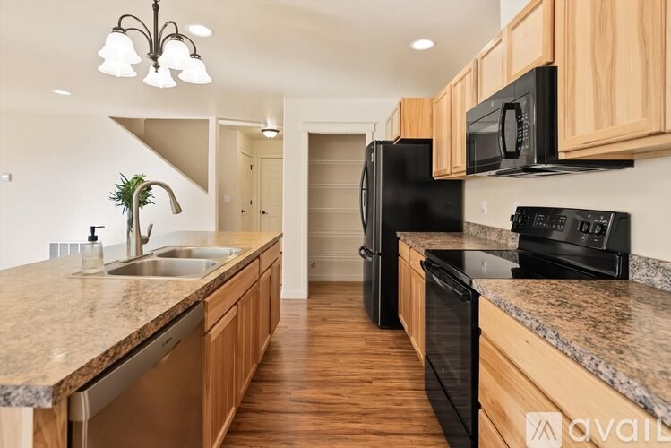 A kitchen with wooden cabinets and granite countertops.