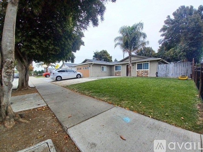 A house with a car parked in front of it.