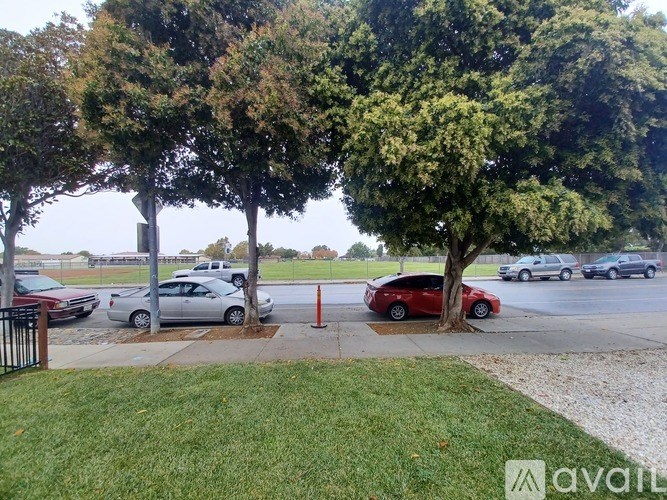 A parking lot with cars and trees.