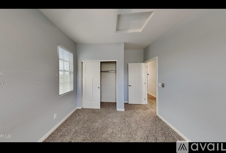 A room with a carpeted floor and white walls.