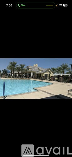 A pool with a house in the background.