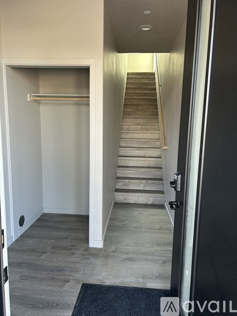 A hallway with a staircase leading to the second floor.