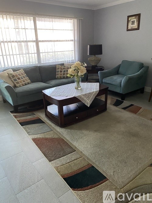 A living room with a couch, chair, and coffee table.
