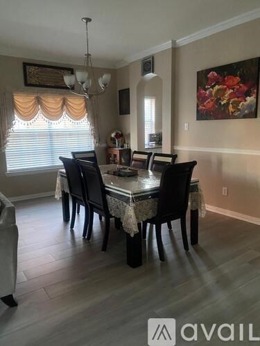 A dining room with a table set for six.