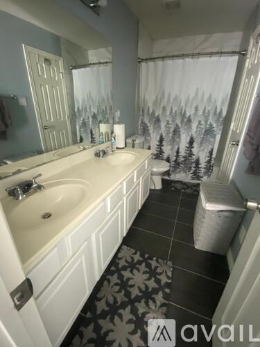 A bathroom with a white sink and a toilet.