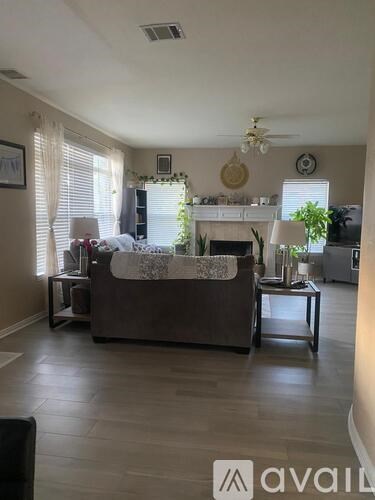 A living room with a couch, a coffee table, and a fireplace.