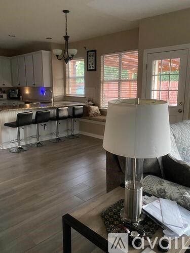 A living room with a white lamp on a coffee table.