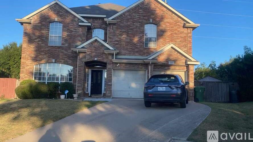 A house with a car parked in front of it.