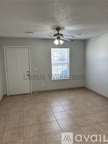 A room with a fan and a door.