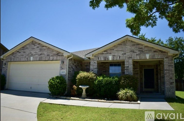 A house with a garage and a driveway in front.