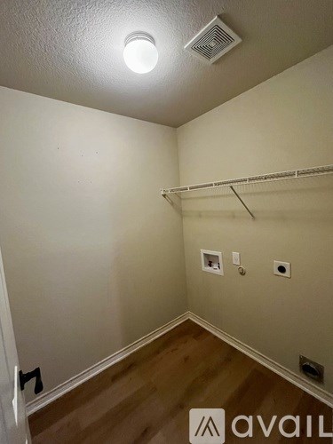A small, empty room with a single light on the ceiling.