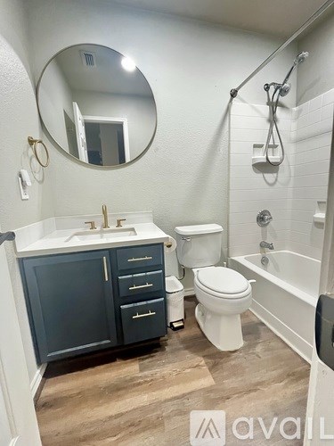 A bathroom with a white sink, a toilet, and a bathtub.