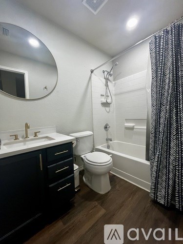 A bathroom with a sink, toilet, and bathtub.