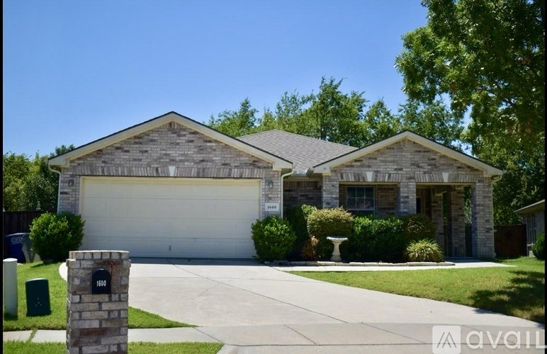 A house with a garage door and a driveway.